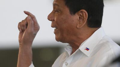 Philippine President Rodrigo Duterte gestures at Manila airport prior to boarding his flight for a three-day official visit to Japan. Bullit Marquez / AP Photo