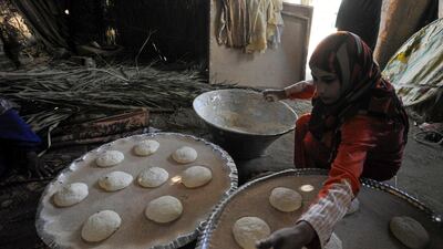 A woman prepares to bake bread to sell to tourists at Saqqara village, near Giza, Egypt.