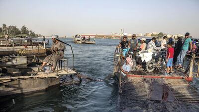 The bridge that connected the two parts of the city of Raqqa was destroyed by air raids. Today, civilians have to use barges to pass from one side to the other. For a story on the disappearance of Father Paolo Dall'Oglio. Arianna Pagani for The National