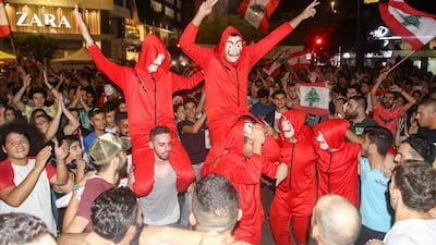 Lebanese protesters, wearing the masks of the Spanish TV show "La Casa de Papel", dance during a protest against dire economic conditions in the Lebanese southern port city of Sidon. AFP