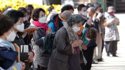 People wearing face masks to help curb the spread of the coronavirus pray during a service at the Chogyesa temple in Seoul, South Korea. South Korea on Monday began testing tens of thousands of employees of hospitals and nursing homes to prevent Covid-19 outbreaks at live-in facilities. AP Photo