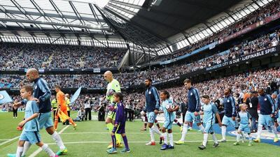 Manchester City players walk out for match. Chris Brunskill / Getty Images