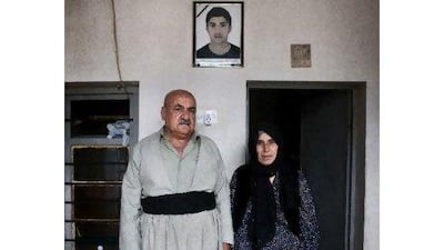 A photograph of Serkio Mahmoud Imam hangs above the head of his parents in their home. The teenager was killed during protests. Lee Hoagland / The National