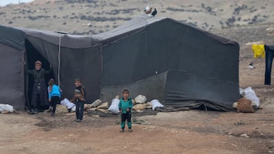 Children play near their tent at the Jabal Bersaya camp. AFP