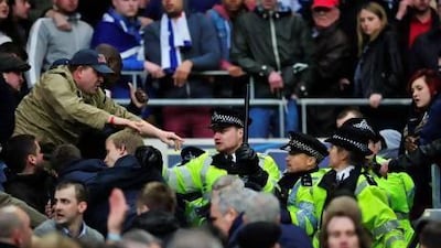 Millwall fans clash with police during the FA Cup semi-final match against Wigan Athletic at Wembley Stadium. Glyn Kirk / AFP