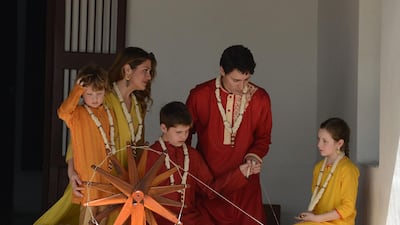 The Trudeaus try out a ceremonial spinning wheel during their visit to Gandhi Ashram in Ahmedabad. Sam Panthaky / AFP Photo