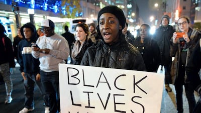 Protesters march on a street in Washington on December 5 during the third night of nationwide protests after a grand jury decided not to charge a white police officer in the choking death of Eric Garner. Mladen Antonov / AFP Photo
