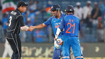 MS Dhoni shakes hands with New Zealand's Ross Taylor as Dinesh Karthik looks on after India win the second ODI. Amit Dave / Reuters