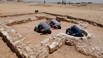 Muslim workers of Israel's antiquities authority pray at the newly discovered remains of an ancient rural mosque, dating back to the era between the 7th and the 8th centuries, in the Israeli Bedouin town of Rahat in the Negev desert on July 18, 2019. AFP