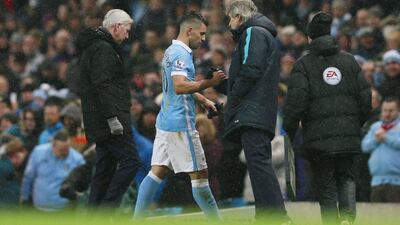 Manchester City manager Manuel Pellegrini with Sergio Aguero as the two-goal striker is substituted. Jason Cairnduff / Reuters