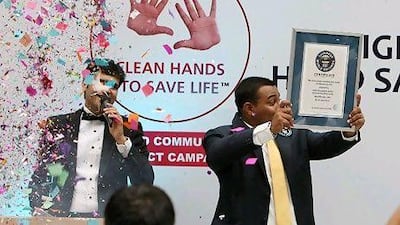 Nikhil Shukla, Guinness World Records India representative, shows the Guinness World Records certificate after the Clean Hands to Save Life campaign at the Centre One Mall in Vashi in Navi Mumbai on Friday.