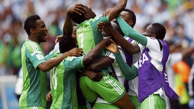 Nigeria's Ahmed Musa, centre, celebrates with his teammates after scoring their second goal against Argentina on Wednesday at the 2014 World Cup in Porto Alegre, Brazil. Darren Staples / Reuters