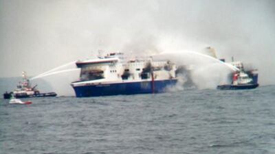 In this photo taken from a nearby ship, vessels try to extinguish the fire at the Italian-flagged “Norman Atlantic” after it caught fire in the Adriatic Sea. Italian and Greek military and coast guard rescue crews battled gale-force winds and massive waves Sunday as they struggled to rescue hundreds of people trapped on a burning ferry adrift between Italy and Albania. At least one person died and two were injured. AP Photo / SKAI TV Station