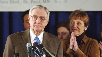 Mondale stands at the podium with his wife Joan as he concedes Senate race to Republican Norm Coleman in 2002. Reuters