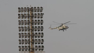 A helicopter flies over Gaddafi Cricket Stadium on Tuesday. KM Chaudary / AP