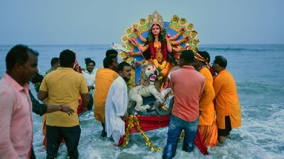 Devotees immerse an idol of the deity Durga into the Bay of Bengal, on the final day of Navratri or Durga puja, at Palavakkam beach in Chennai, India. EPA