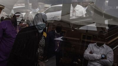 The casket containing the remains of Njabulo Allen Dlamini (31) a father of 11, taxi driver killed in Phoenix, Durban, on July 12 allegedly by a group of South African Indians resident manning a roadblock while defending their properties from looters, arrives on July 21, 2021 for its funeral service at his home. - Phoenix is flashpoint town between black South Africans and counterparts of Indian origin where at least 20 people died in the recent wave of violence. Like communities across South Africa, residents of the predominantly ethnic Indian town set up their own protection squads in response to pillaging and arson that broke out days after the jailing of ex-president Jacob Zuma on July 8th -- overwhelming security forces.