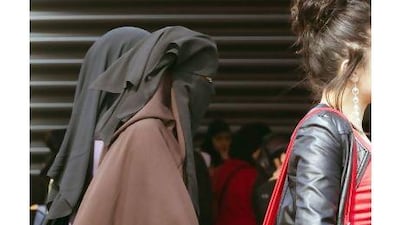 Paris's 200-year-ban on women wearing trousers - an absurd law that was lifted this week - was never equivalent to the French law that bans full face veils, a reader argues. Joel Saget / AFP