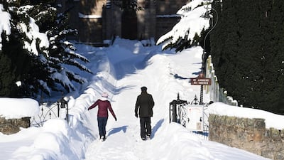 People walk along a snow covered lane in Braemar. Getty Images