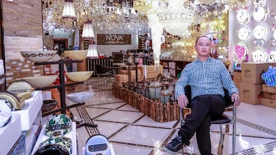 “My family is here, my business is here so my home is here,” says Lejun Bao, who runs a shop at Dubai’s Dragon Mart. Victor Besa for The National