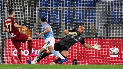 Roma's Armenian midfielder Henrikh Mkhitaryan shoots to open the scoring past Lazio's Spanish goalkeeper Pepe Reina. AFP