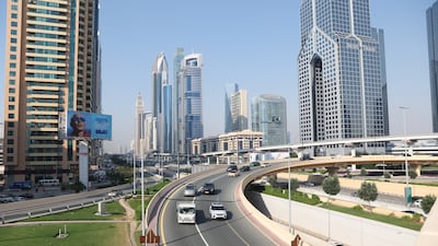 Vehicles drive towards Sheikh Zayed road in Dubai after it was drained of flood water . EPA