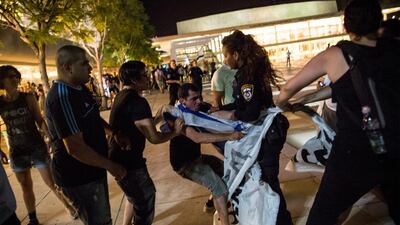 Right- and left-wing Israelis clash at a rally in Tel Aviv last month calling for an end to the occupation and for a ceasefire. Andrew Burton / Getty Images