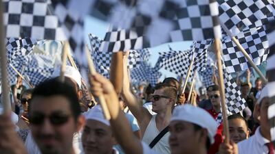 Two hundred and fifty eight people set a new world record on Abu Dhabi’s Corniche for the most number of people waving chequered flags in one place. Sammy Dallal / The National