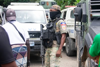 A Haitian stands guard in the Kenscoff area of the country after unrest. EPA