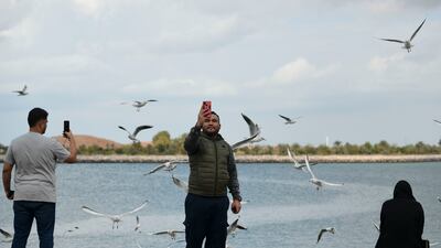 People enjoy the cool weather in Corniche, Abu Dhabi. Khushnum Bhandari / The National