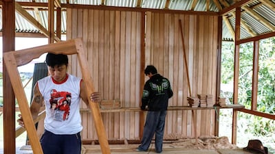 Woloan workers contruct a prefabricated wooden house. Orders have arrived from as far away as Argentina, Norway, Poland, Japan, South Korea, the Philippines and the United States for these simple traditional wooden houses. Putu Sayoga / Getty Images