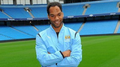 Manchester City's new signing Joleon Lescott poses for photographs during a photocall at the City of Manchester Stadium. City manager Mark Hughes has not ruled out further signing.