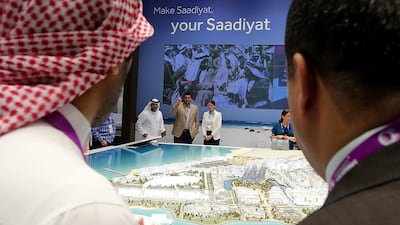 Visitors take a look at models of Saadiyat Cultural District projects at the Abu Dhabi stand in Cityscape Global 2014. Satish Kumar / The National