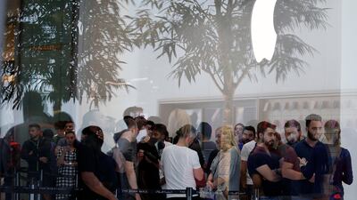 Customers queue outside the Apple store at Dubai Mall. Mahmoud Khaled / EPA