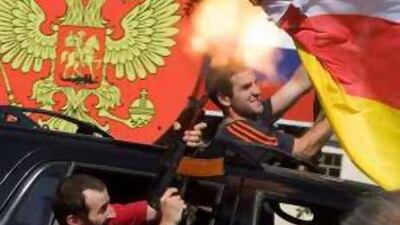 South Ossetian separatist fighters celebrate yesterday's recognition of independence by Russia.