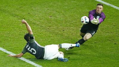 England’s Jack Butland saves from Germany’s Mats Hummels. Reuters / Hannibal Hanschke