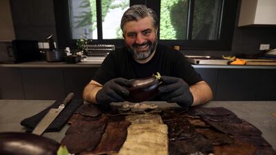 Omar Sartawi, a Jordanian chef, presents eggplant peels after processing them to produce a type of leather to make sustainable face masks, at his kitchen in Amman, Jordan. Reuters