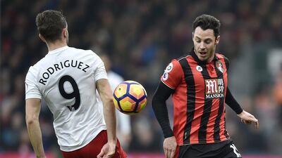 Bournemouth’s Adam Smith in action with Southampton’s Jay Rodriguez. Hannah McKay / Reuters