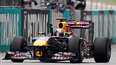 Sebastian Vettel signals his victory as he takes the chequered flag to win in Malaysia. The win makes the German two for two to open the 2011 season and four straight dating back to last season.