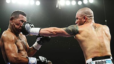 Miguel Cotto, right, connects with a left-hook during his WBA super-welterweight defence against Ricardo Mayorga.