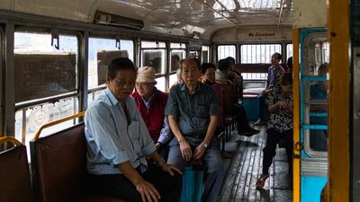 Members of the Chinese Indian community board the bus which will take them to Achipur. All Photos: Puja Bhattacharjee for The National