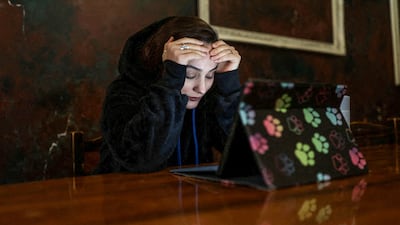 An Iranian woman reacts as she tries to connect to the internet to check on her visa status for her migration process, after a nationwide internet shutdown. Reuters