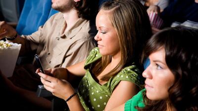 Readers urge moviegoers to keep all mobile phone use until after the film. iStockphoto