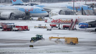 A tractor clears snow from the runways at Manchester Airport. Reuters