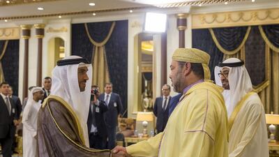 Sheikh Nahyan bin Zayed, Chairman of the Board of Trustees of the Zayed bin Sultan Al Nahyan Charitable and Humanitarian Foundation, left, greets King Mohammed VI of Morocco, second right, during a reception held at Mushrif Palace. Sheikh Mohammed bin Zayed, Crown Prince of Abu Dhabi and Deputy Supreme Commander of the Armed Forces, right, looks on. Mohamed Al Hammadi / Crown Prince Court - Abu Dhabi