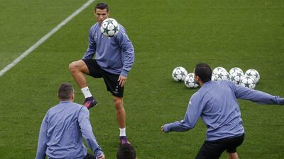 Real Madrid’s Cristiano Ronaldo, background, controls the ball with teammates during training. Francisco Seco / AP Photo