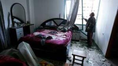 A Palestinian man inspects his damaged bedroom after an Israeli air strike on the neighbouring Education Ministry building in Gaza.