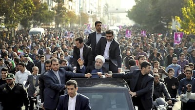 Iranian president Hassan Rouhani, centre, waves to his well-wishers from his car during a public welcoming ceremony for him upon his arrival in Karaj, 35 kilometres west of the capital Tehran, Iran on November 16, 2016. Rouhani says his country will remain committed to a landmark nuclear deal with world powers regardless of the US presidential election result. Iranian Presidency Office via AP