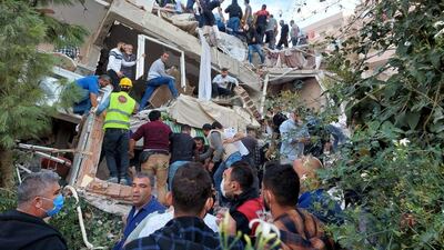 Locals and officials search for survivors at a collapsed building after a strong earthquake struck the Aegean Sea on Friday and was felt in both Greece and Turkey, where some buildings collapsed in the coastal province of Izmir, Turkey, October 30, 2020. REUTERS/Tuncay Dersinlioglu