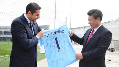 Manchester City chairman Khaldoon Al Mubarak presents Chinese president Xi Jinping a Manchester City jersey signed by the club's players. Wam